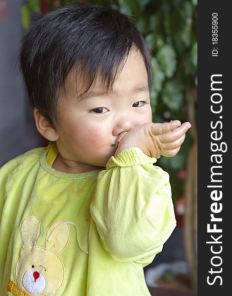 A cute baby is eating in restaurant