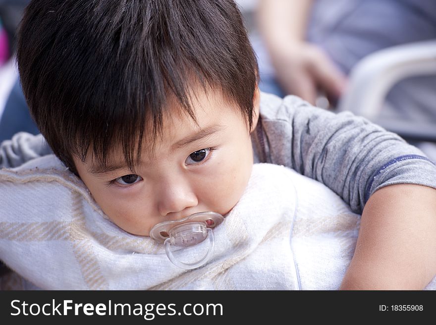 A cute baby is sleeping and look at photographer. A cute baby is sleeping and look at photographer