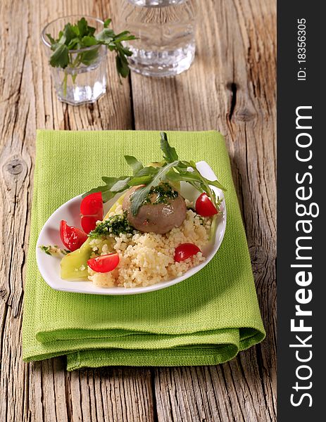 Couscous, button mushroom with pesto and fresh vegetables. Couscous, button mushroom with pesto and fresh vegetables