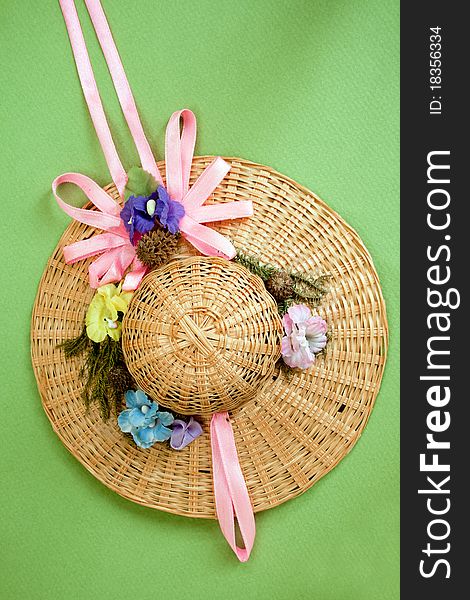 Small summer hat for doll isolated oer green background