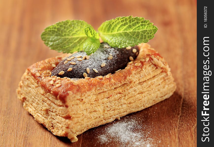 Puff pastry with chocolate filling sprinkled with sesame seeds