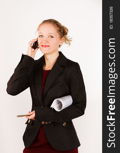 Business woman with the folder of documents and telephone on a white background. Business woman with the folder of documents and telephone on a white background