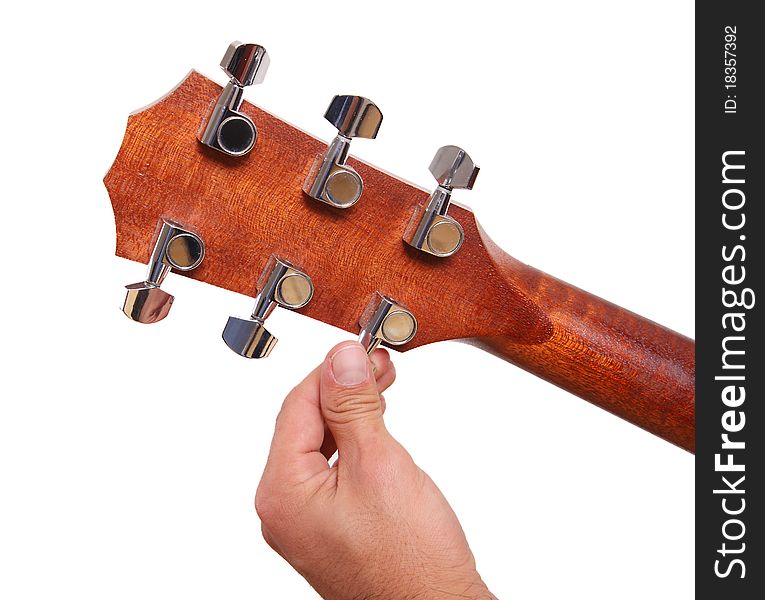 Person tuning a guitar from its headstock over white background