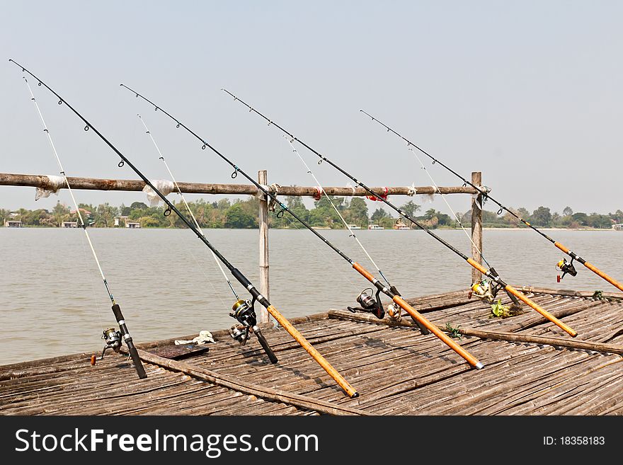 Fishing Poles on Pier with river in Background