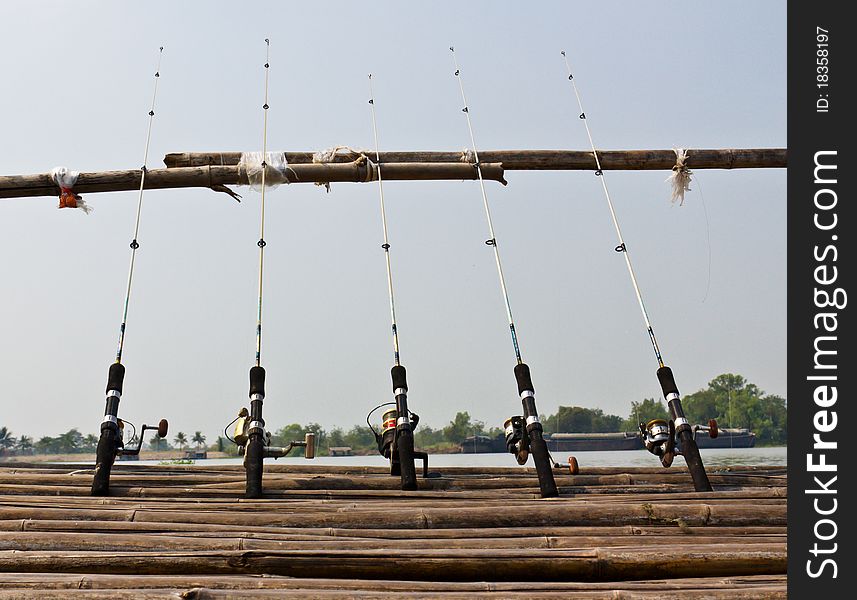 Fishing Poles on Pier with river in Background