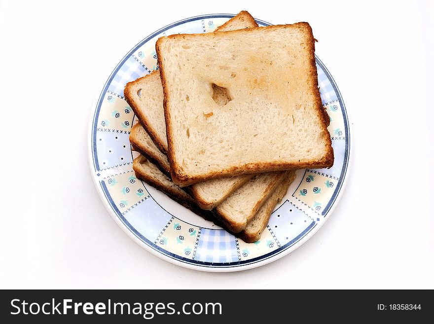 Bread toast on plate isolated against a plain background