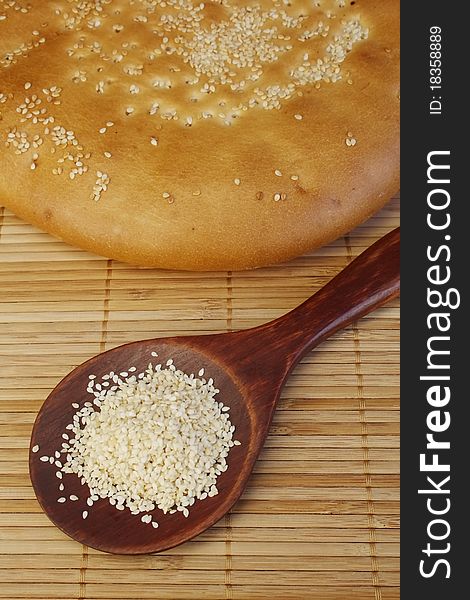 Rustic roll bread with sesame on a table