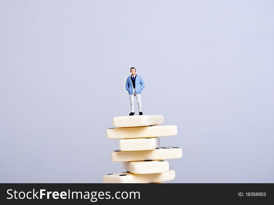 One man standing on pile of domino cubes