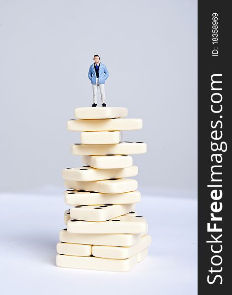 One man standing on pile of domino cubes