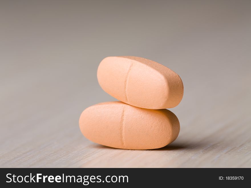 Pills on a wooden table