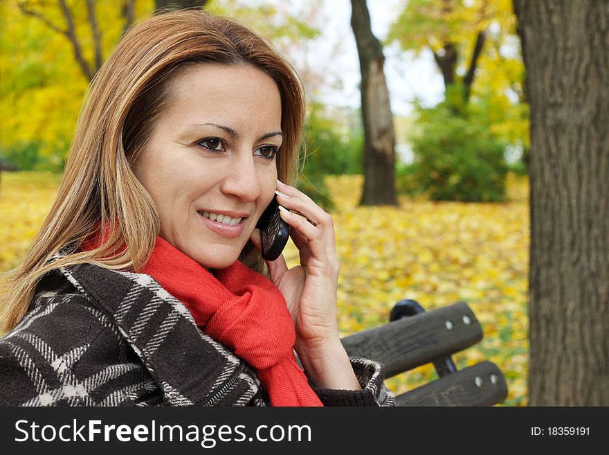 Woman in Park talking on a mobile phone