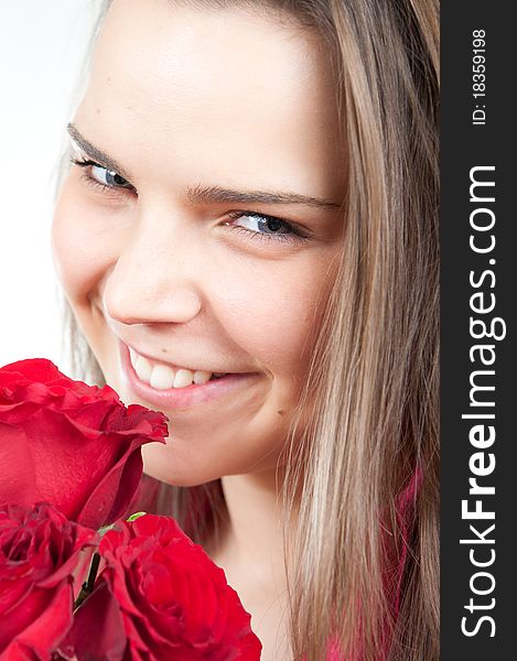 Attractive young holding a bouquet of roses woman smiling. Attractive young holding a bouquet of roses woman smiling