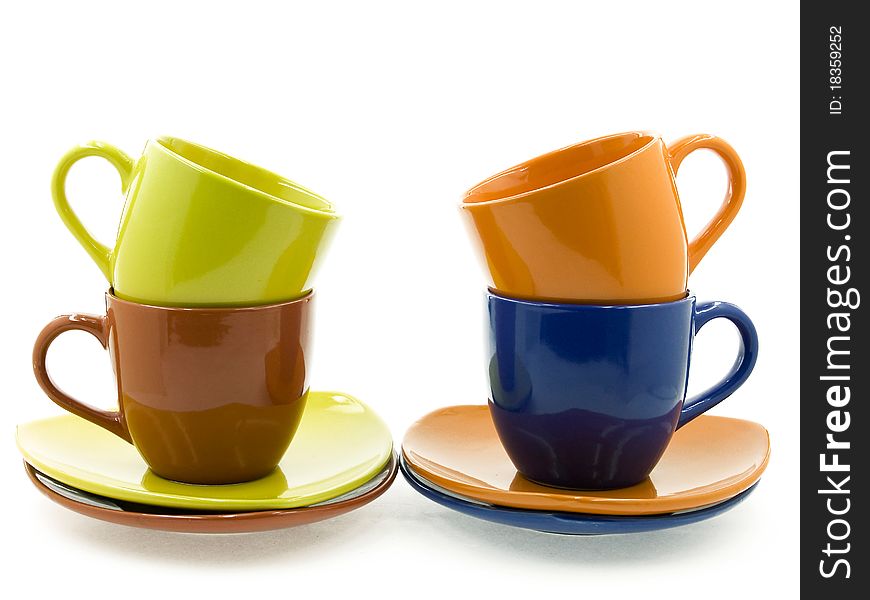 Two cups on two saucers standing beside the other two cups on two saucers. Two cups on two saucers standing beside the other two cups on two saucers