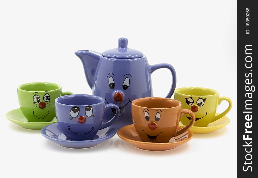 Four kid's tea cups on saucers with a teapot.There are curious smiling faces on one side of five subjects. Four kid's tea cups on saucers with a teapot.There are curious smiling faces on one side of five subjects