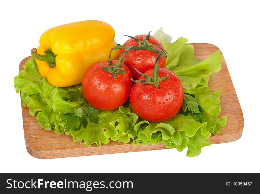 Fresh colorful vegetables on wooden board isolated on white. Fresh colorful vegetables on wooden board isolated on white