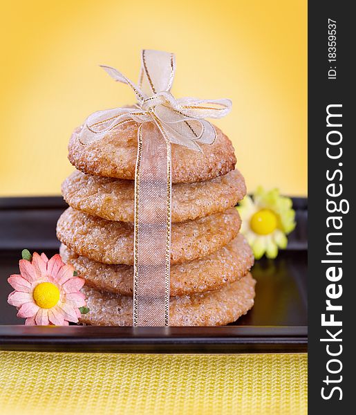 Ginger cookies tied with ribbon on black plate. Ginger cookies tied with ribbon on black plate