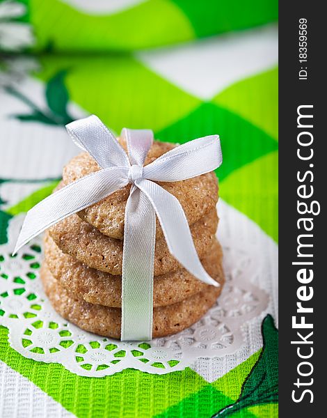 Stack of ginger cookies tied with white ribbon