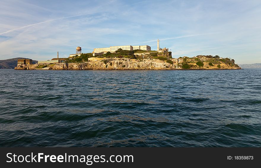 Wide angle panorama of Alcatraz Island and prison in warm afternoon light.