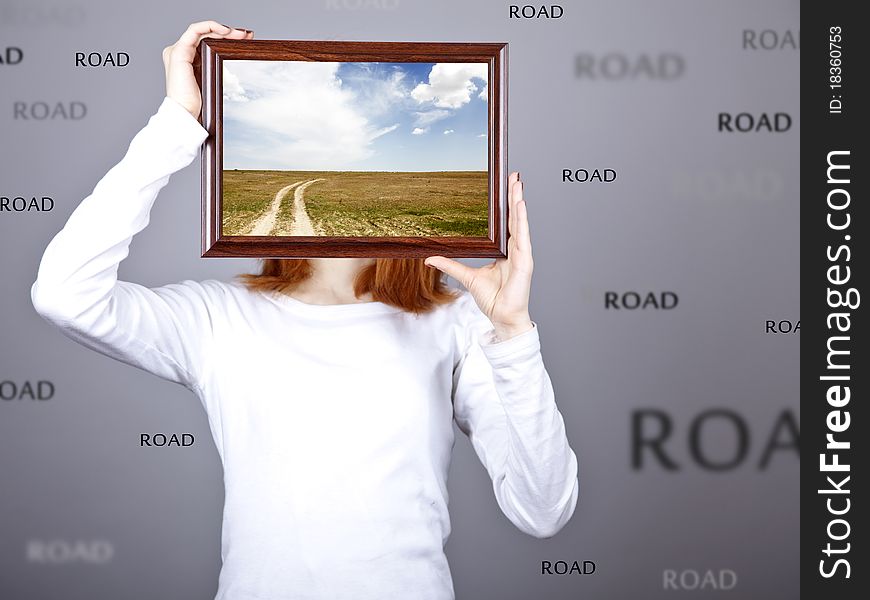 Girl keep frame with village road inside.