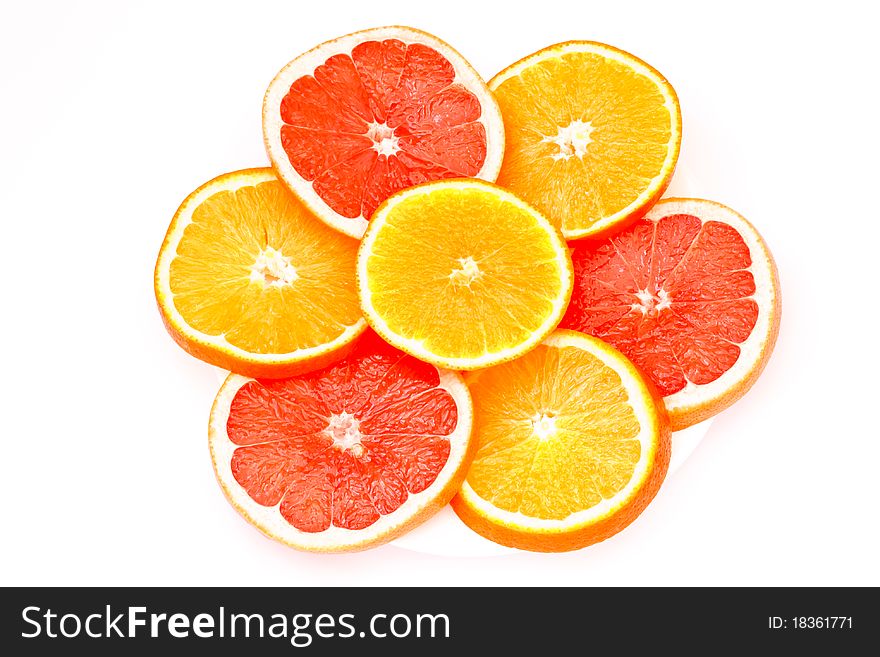 Grapefruit and orange slices cut into isolated on a white background