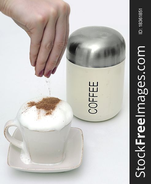 Sprinkle coffe with chocolate and coffee can.