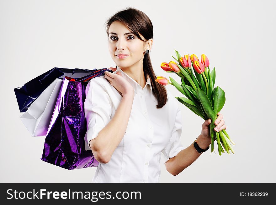An image of nice woman with tulips and with bags. An image of nice woman with tulips and with bags