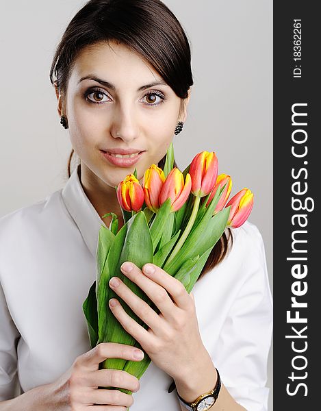 A young woman holding a bunch of tulips. A young woman holding a bunch of tulips