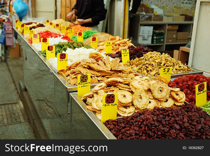 Close up of many colorful dried fruits on market stand