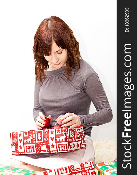 Young lady open boxes with presents