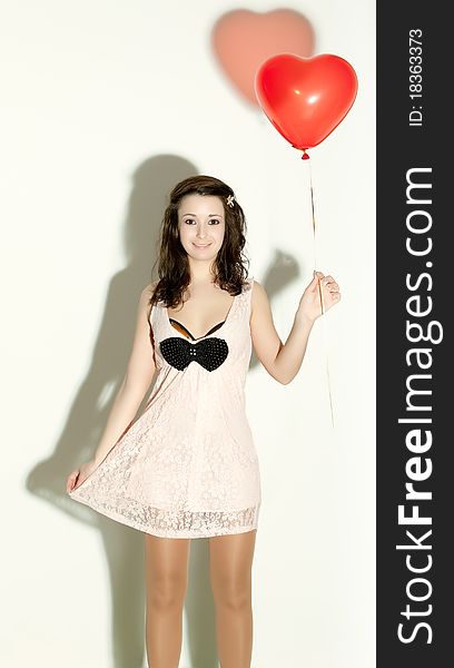 Photo of a young woman , holding red inflatable Valentines Day heart. Photo of a young woman , holding red inflatable Valentines Day heart.