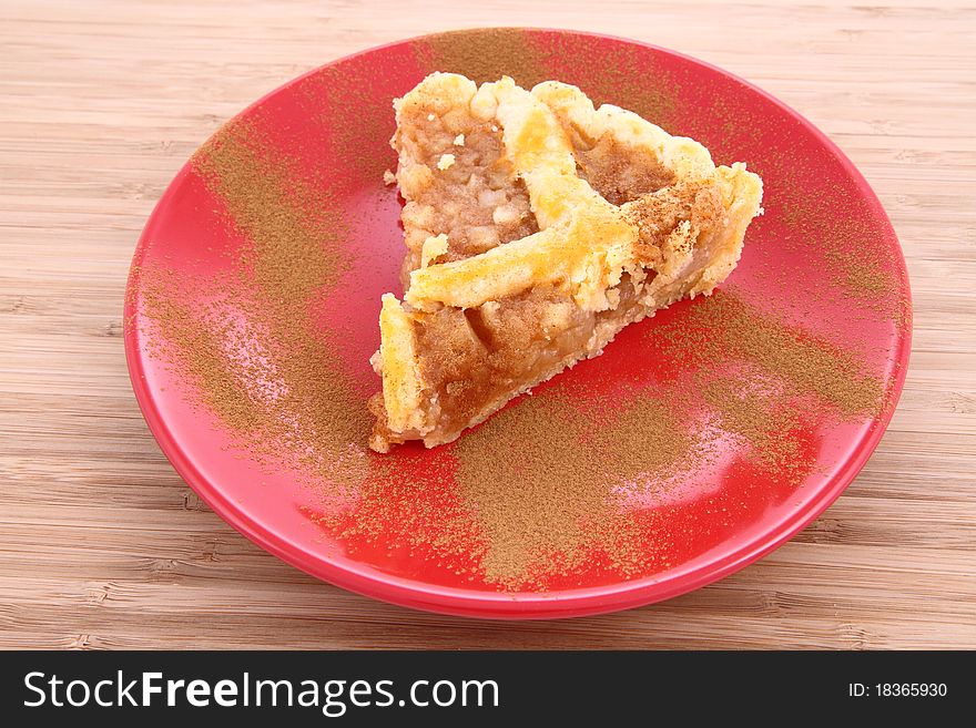 Apple Pie - a slice on a plate decorated with cinnamon