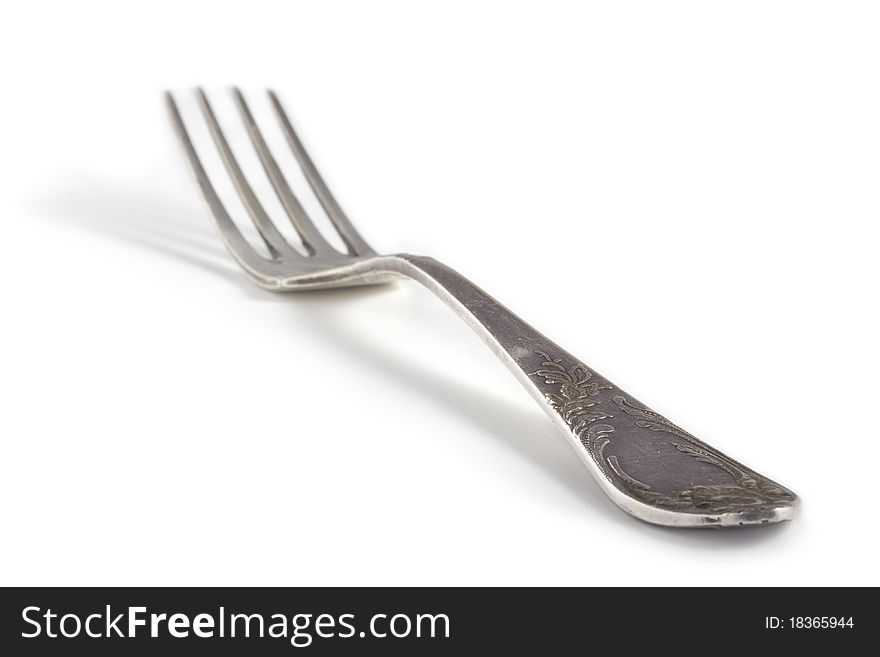 Old silver fork with ornaments, shallow depth of field