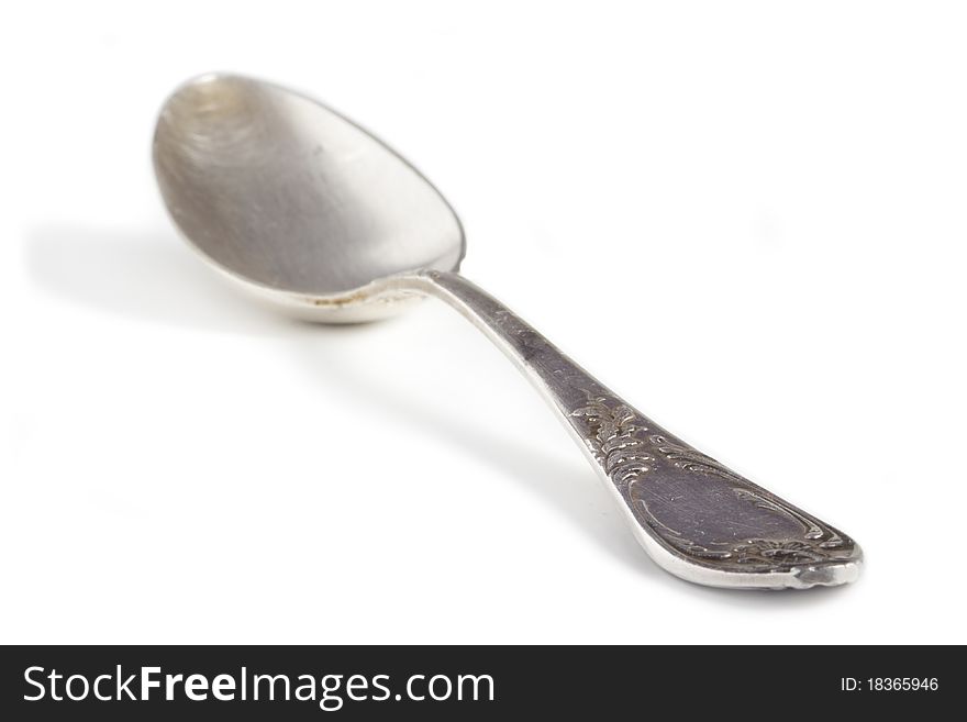 Old silver spoon with ornaments, shallow depth of field