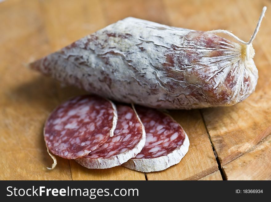 Salami pieces on wood table