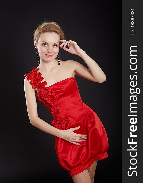 Fashion girl in red dress on black background. Fashion girl in red dress on black background