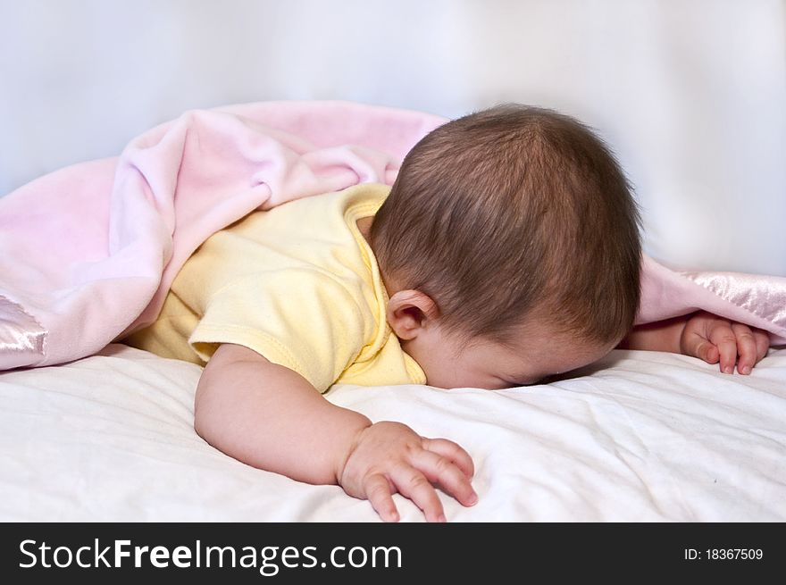 Little girl throws her head in the pillow during the shoot hoping it will be over real soon !!!. Little girl throws her head in the pillow during the shoot hoping it will be over real soon !!!