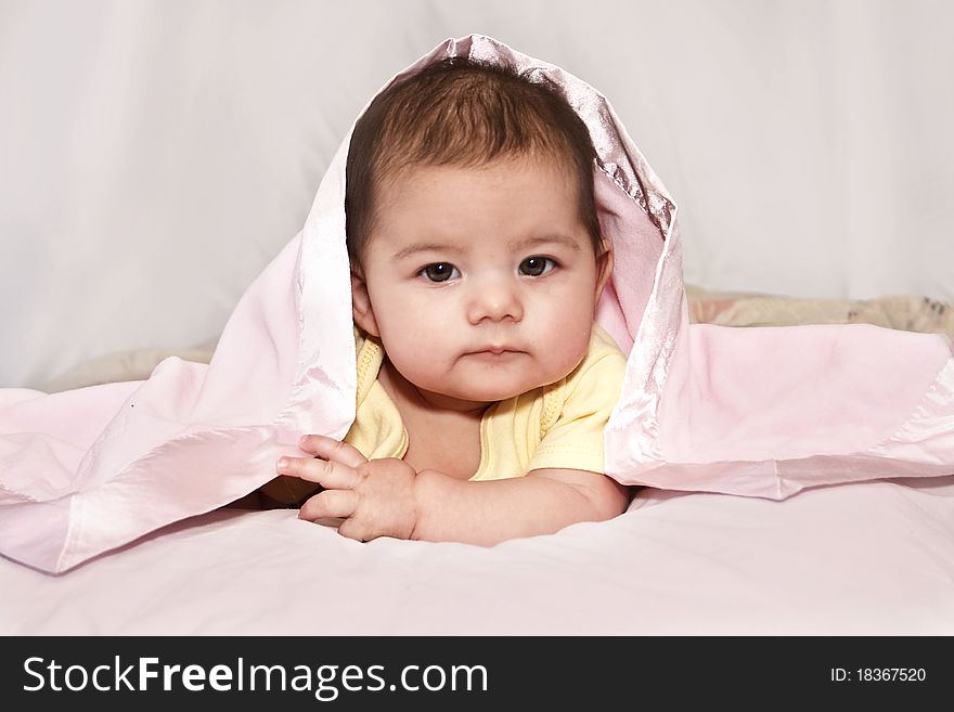 Beautiful little girl all wrapped in her pink blanket. Beautiful little girl all wrapped in her pink blanket