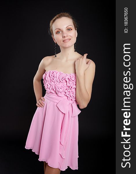 Fashion girl in pink dress on black background. Fashion girl in pink dress on black background