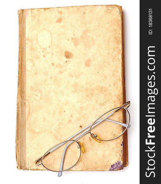 Old book with eyeglass on white background