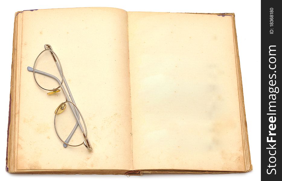 Opened old book with eyeglass