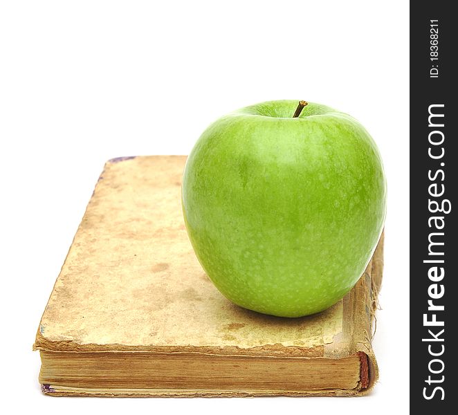 Old book with apple isolated on white background