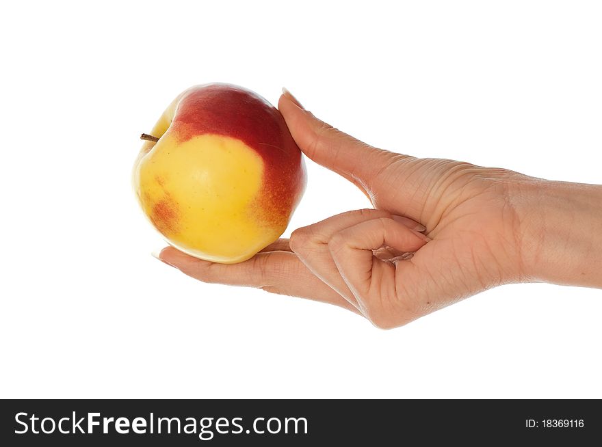 Woman holding in the hand one fresh yellow with red-edged apple