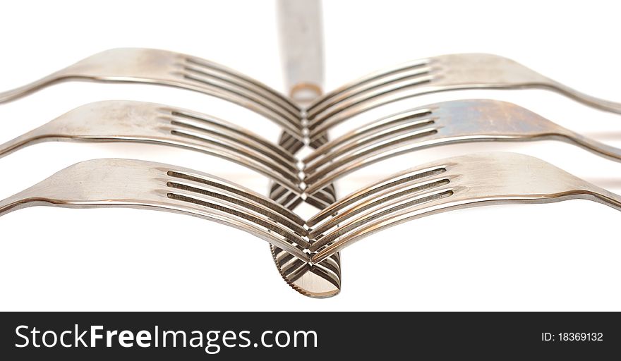 Closeup abstract of a silver knife and fork on a white background