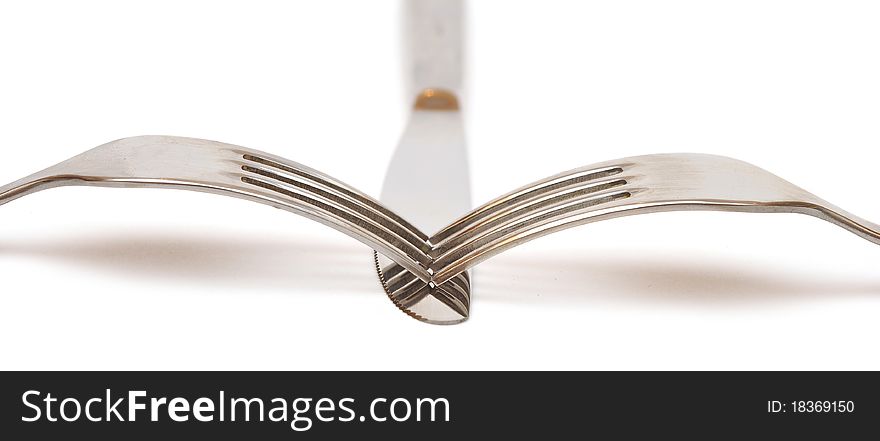 Closeup abstract of a silver knife and fork on a white background with space for text