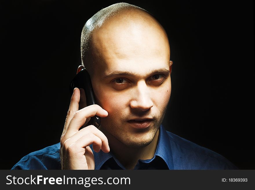 A studio shoot of a young handsome man with phone