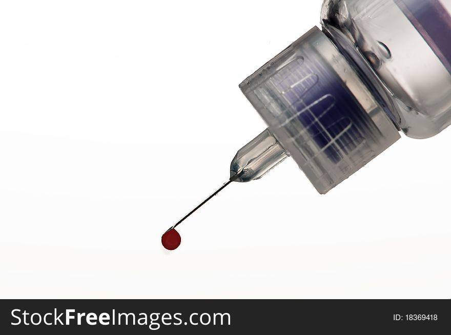 Insulin syringe with blood dripping of needle tip. Insulin syringe with blood dripping of needle tip