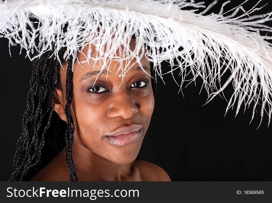 Afro-american woman with white feather against black background. Afro-american woman with white feather against black background