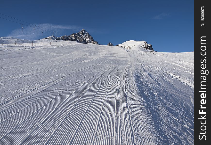 Ski slope with Crissolo Monviso to dominate the landscape