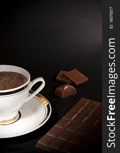 Art, luxury chocolate hot drink and milk chocolate bars on black background