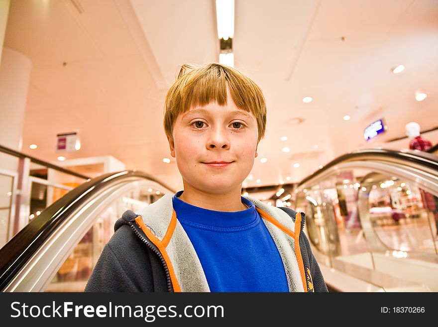 Child On Moving Staircase Looks Self Confident